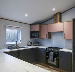 A kitchen with a sink and microwave at Laurel Waterside Spa Carlton Miniott near Thirsk