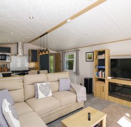 A living room with a sofa and television at 51 Calgarth Park in Troutbeck