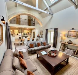 A living room with a sofa and coffee table at The Chimney in Bamburgh