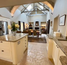 A kitchen with a dining area and living space at The Chimney in Bamburgh