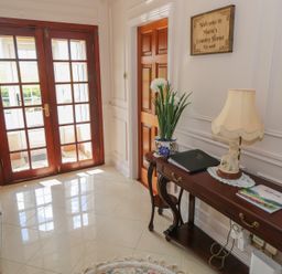 A hallway with double doors and a table with a lamp at Marie's Country Home in Ardee, County Louth