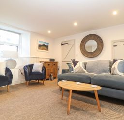 A living room with seating and decor at Ty Bryn in Marazion
