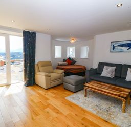 A living room with a sofa and coffee table at Apartment 1, Bryn Mel Manor Menai Bridge