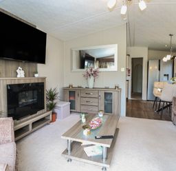 A living room with a television and coffee table at The Norfolk Nook 18 Castle Walk Burgh Castle
