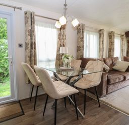 A dining room with a table and chairs at The Norfolk Nook 18 Castle Walk Burgh Castle