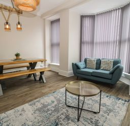 A dining area with a table and benches at Llety Cllyd in Barmouth