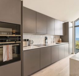 A kitchen with cabinets and appliances at Clifftop House Hot Tub St Ives