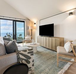 A living room with a sofa, coffee table, and television at tbc in St. Ives