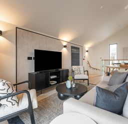 A living room with a sofa, chairs, and a television at tbc in St. Ives