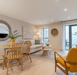 A living room with a sofa and dining table at Hidden 19- Coastal Hot Tub St Ives
