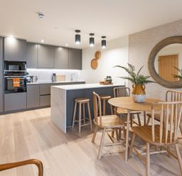 A kitchen with a table and chairs at Hidden 19- Coastal Hot Tub in St Ives