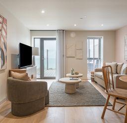A living room with a television and sofa at tbc in St. Ives