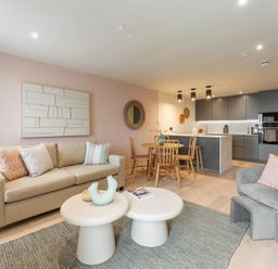 A living room with a sofa and dining table at tbc in St. Ives