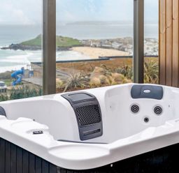A hot tub with a view overlooking the beach at tbc in St. Ives