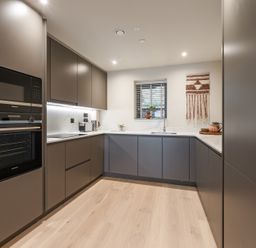 A kitchen with cabinets, oven and sink at tbc in St. Ives