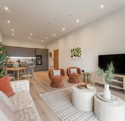 A living room with a sofa, dining area and kitchen at tbc in St. Ives