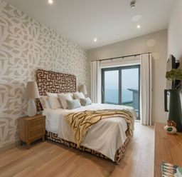 A bedroom with a bed and sliding door at tbc in St. Ives
