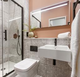 A bathroom with a shower, toilet, and sink at tbc in St. Ives
