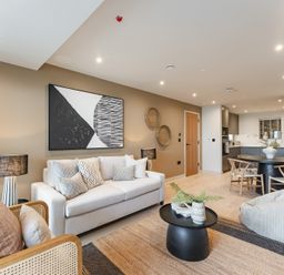 A living room with a sofa and dining table at tbc in St. Ives