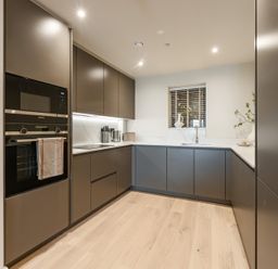 A kitchen with cabinets, oven, sink and window at tbc in St. Ives