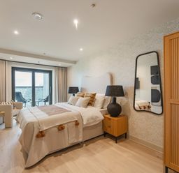 A bedroom with a bed and nightstand at tbc in St. Ives