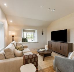 A living room with a sofa and television at tbc in St. Ives