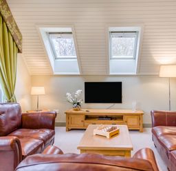 A living room with a television and seating area at The Derwent Spa (Pet) Slaley