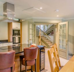 A kitchen with an island and dining area at The Derwent Spa (Pet) in Slaley