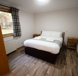 A bedroom with a bed and bedside tables at Sidlaw Fowlis near Dundee