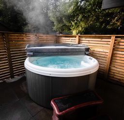 A hot tub on a stone patio at Sidlaw Spa Fowlis near Dundee