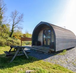 A cabin with picnic table in front at Bron Eifion Pod 1 Criccieth