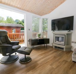 A living room with a recliner chair and television at Fox Red Retreat in Troutbeck Bridge