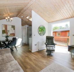 A living room with a sofa and table at Fox Red Retreat Troutbeck Bridge