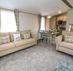 A living room with two sofas and a dining table at Hedgehog Lodge Carnforth