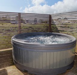 A hot tub in an outdoor area at Stone Crab Lodge in Haverfordwest