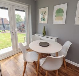 A dining room with a round table and chairs at 26 Field Court