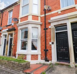 A front exterior view of a building with brick walls and doors at 17 Fairfield Road