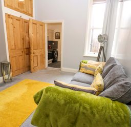 A living room with a sofa and a door at 17 Fairfield Road