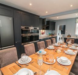 A kitchen with dining table and appliances at 5 Station Avenue