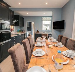 A kitchen with a dining table set for meals at 5 Station Avenue