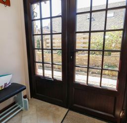 A hallway with double doors and a bench at Dunvant in Swanage