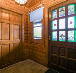 An entrance with a wooden door and stained glass door at Lodge 6 - Sleep 4 - Twin and Double Criccieth