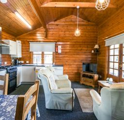 A living room with a kitchen area and seating at Lodge 6 - Sleep 4 - Twin and Double in Criccieth