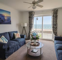 A living room with sofas and a coffee table at 2 Lyme Mews in Seaton