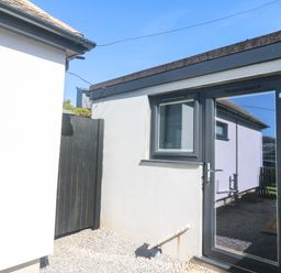 An outdoor area with a door and window at The Annex in Penzance