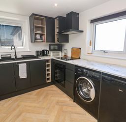 A kitchen with appliances and cabinets at The Annex in Penzance
