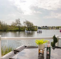 An outdoor area with a lake and swan-shaped boats at Swan Haven in Grange-Over-Sands