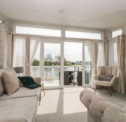 A living room with a view of the water at Swan Haven in Grange-Over-Sands
