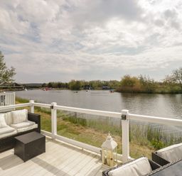 A river view with seating and boats at Swan Haven Grange-Over-Sands