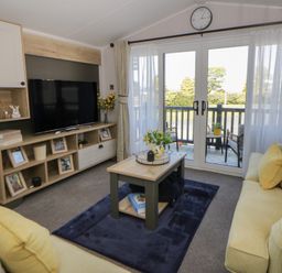 A living room with a TV and coffee table at Santa Maria in Llandysul